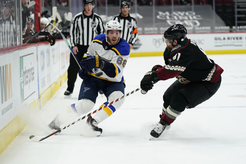 St. Louis Blues left wing Mike Hoffman (68) and Arizona Coyotes right wing Phil Kessel battle for the puck in the first period during an NHL hockey game, Monday, Feb. 15, 2021, in Glendale, Ariz. (AP Photo/Rick Scuteri)