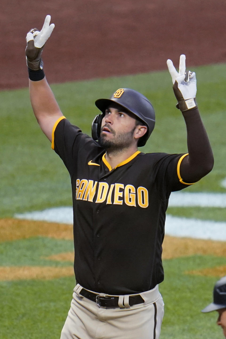 San Diego Padres' Eric Hosmer celebrates as he crosses home plate after hitting a three-run home run off Pittsburgh Pirates starting pitcher JT Brubaker during the fourth inning of a baseball game in Pittsburgh, Saturday, April 30, 2022. (AP Photo/Gene J. Puskar)
