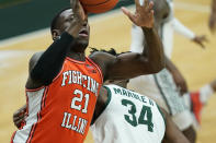 Illinois center Kofi Cockburn (21) makes a layup as Michigan State forward Julius Marble II (34) defends during the first half of an NCAA college basketball game, Tuesday, Feb. 23, 2021, in East Lansing, Mich. (AP Photo/Carlos Osorio)