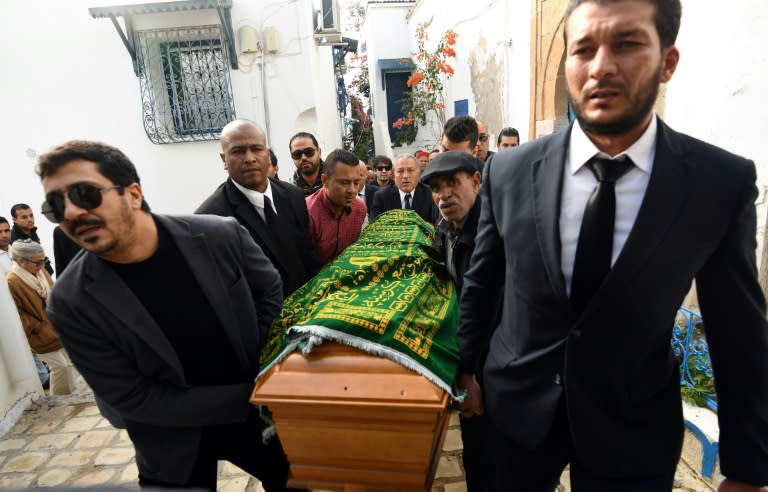 Tunisian mourners carry the coffin of late French-Tunisian fashion designer Azzedine Alaia, who died this month aged 77, during his funeral in the Sidi Bou Said cemetery in the capital Tunis on November 20, 2017