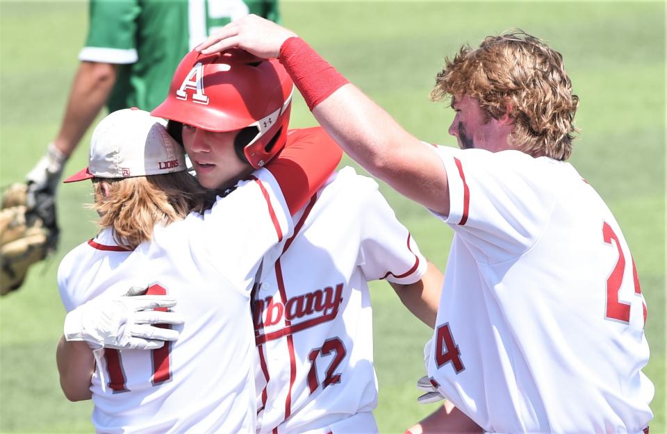 Albany players mob Cole Chapman, center, after his game-winning, walk-off hit in the bottom of the seventh inning against Eldorado. Chapman's hit lifted the Lions to a 3-2 victory over the Eagles in Game 1 of the best-of-three Region I-2A area playoff series Thursday, May 12, 2022, at ACU's Crutcher Scott Field.