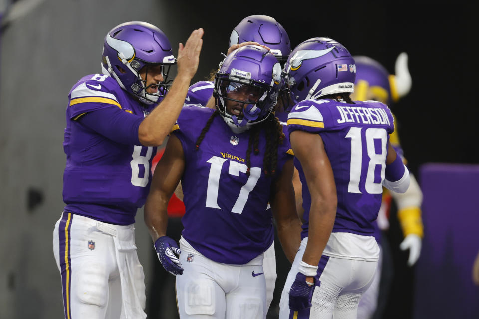 Minnesota Vikings wide receiver K.J. Osborn (17) celebrates with teammates quarterback Kirk Cousins (8) and wide receiver Justin Jefferson (18) after catching a 36-yard touchdown reception during the second half of an NFL football game against the Los Angeles Chargers, Sunday, Sept. 24, 2023, in Minneapolis. (AP Photo/Bruce Kluckhohn)