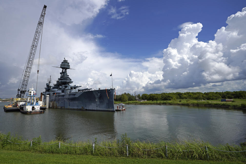 Work continues at the USS Texas in preparation for moving and repairs Tuesday, Aug. 30, 2022, in La Porte, Texas. TheUSS Texas, which was commissioned in 1914 and served in both World War I and World War II, is scheduled to be towed down the Houston Ship Channel Wednesday to a dry dock in Galveston where it will undergo an extensive $35 million repair. (AP Photo/David J. Phillip)