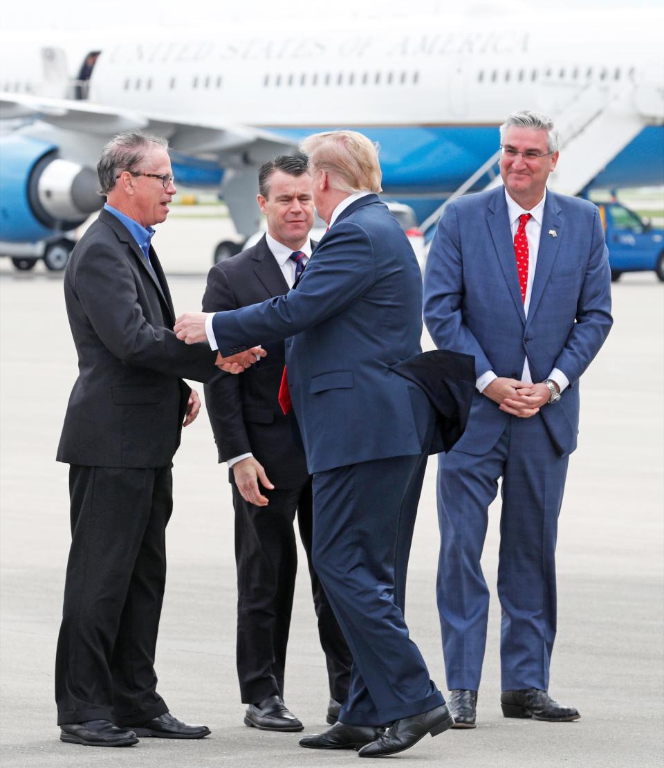 President Donald Trump shakes hands with Sen. Mike Braun as Sen. Todd Young and Gov. Eric Holcomb look on after the president arrived at the Indianapolis International Airport on Friday, April 26, 2019. Trump will speak at the NRA Institute for Legislative Action (NRA-ILA) Leadership Forum at Lucas Oil Stadium.