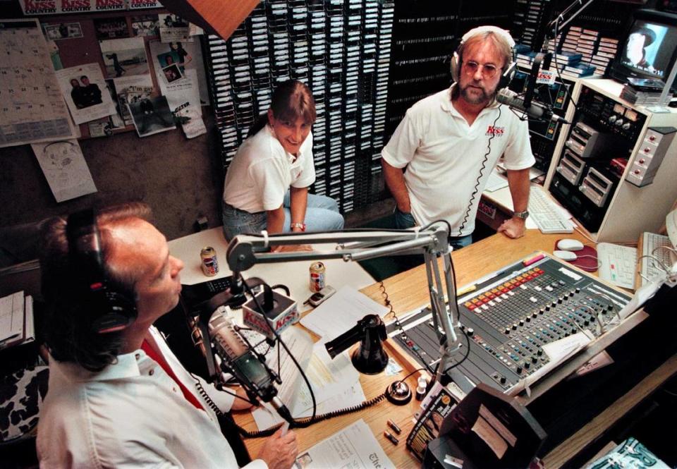 WKIS KISS Country radio station on July 21, 1999. DJs Ron Hersey, Morning Show Producer Janet Speziale, and DJ Sonny Fox in the DJ booth during their morning show.