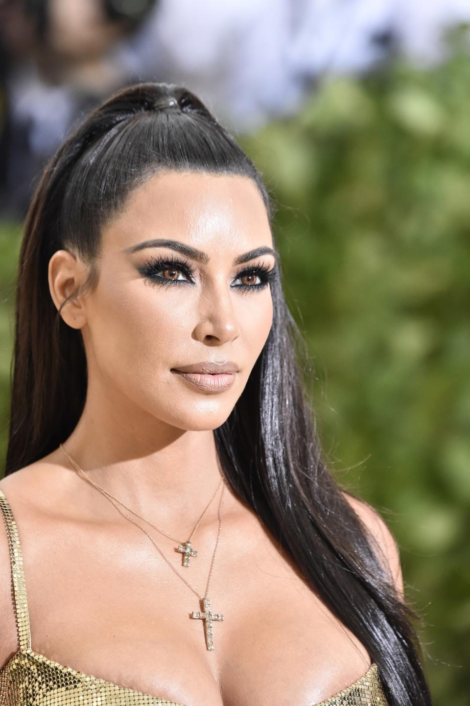 Kim Kardashian and Mario Dedivanovic used golden colored contacts to complement her '90s-inspired KKW Beauty Met Gala 2018 glam.