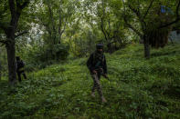 Soldiers patrol near the site of attack on Sunil Kumar, a Kashmiri Hindu man locally known as Pandit, at Chotigam village, some 62 kilometers south of Srinagar, Indian controlled Kashmir, Tuesday, Aug. 16, 2022. Pandit was shot dead by suspected rebels at an apple orchard on Tuesday morning, while his brother was injured in the attack, officials said. (AP Photo/Mukhtar Khan)