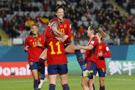 Spain's Jennifer Hermoso jumps into the arms of teammate Alexia Putellas celebrating after scoring her side's second goal during the Women's World Cup Group C soccer match between Spain and Zambia at Eden Park in Auckland, New Zealand, Wednesday, July 26, 2023. (AP Photo/Abbie Parr)