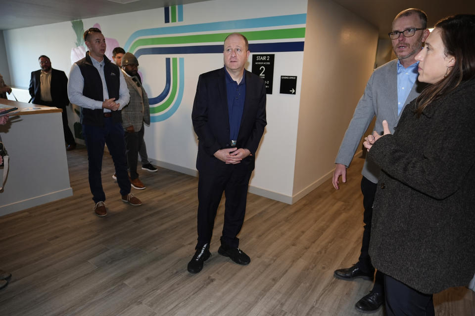 Colorado Gov. Jared Polis tours during the grand opening of the Rose on Colfax, a new affordable housing community with a co-located childcare center in the East Colfax neighborhood Wednesday, Jan. 24, 2024, in Denver. Mercy Housing, Inc., the nation's largest affordable housing nonprofit that is located in Denver, joined forces with the city of Denver and private and nonprofit organizations to build the 82-unit development in a section of the city that is undergoing rapid gentrification. (AP Photo/David Zalubowski)