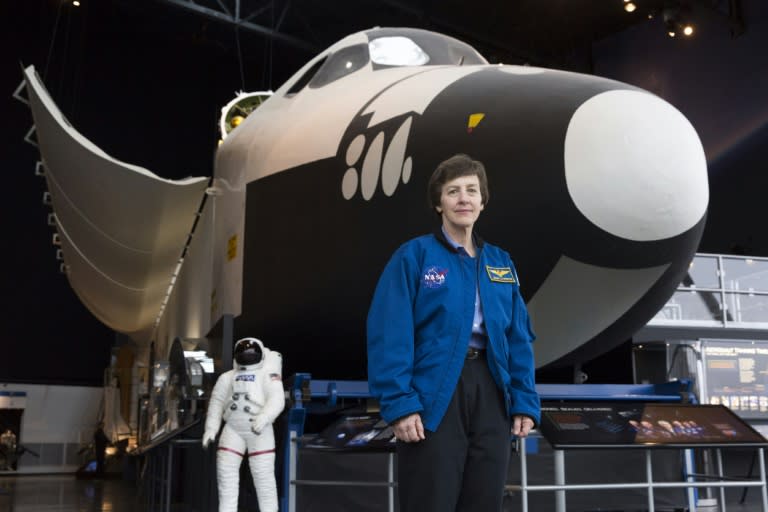 Wendy Lawrence, a retired US Navy captain and former NASA astronaut, stands next to the Space Shuttle trainer that was used for astronaut training, now at the Museum of Flight in Seattle