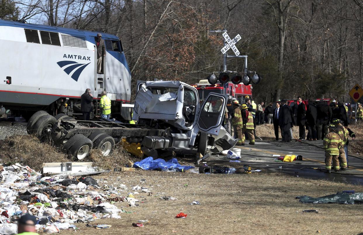 Emergency personnel work at the scene of a train crash involving a garbage truck in Crozet, Virginia: AP