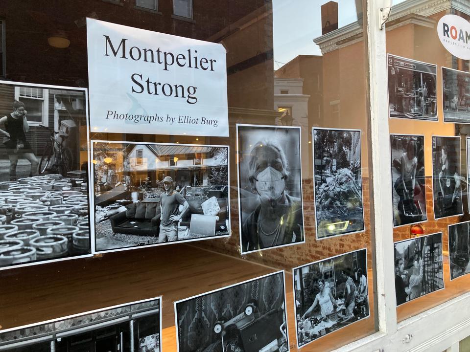 A "Montpelier Strong" photo exhibit, shown Dec. 15, 2023, decorates the window of an empty storefront five months after flooding devastated the city's downtown.