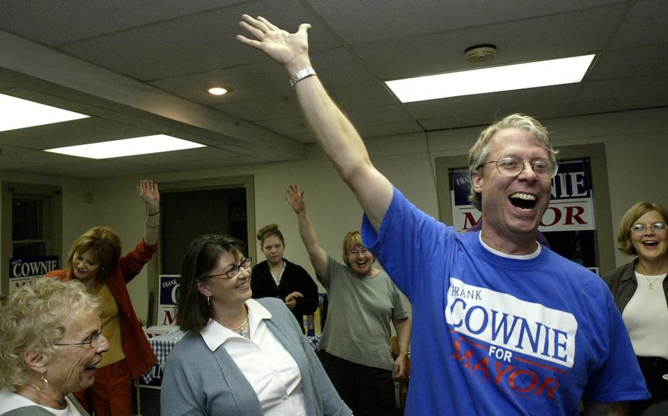 Frank Cownie and his supporters celebrate his unofficial second-place finish in the Des Moines mayoral primary. Moments before, at left, the scene at Cownie's headquarters was tense as the candidate, his daughter Katie, seated, and other supporters monitored election results on Oct. 7, 2003.