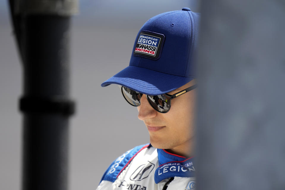 Alex Palou, of Spain, stands in the pit area before practice for an IndyCar Series auto race, Friday, July 21, 2023, at Iowa Speedway in Newton, Iowa. (AP Photo/Charlie Neibergall)