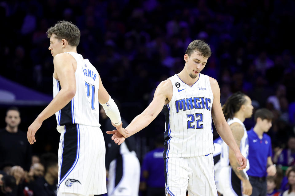PHILADELPHIA, PENNSYLVANIA - JANUARY 30: Moritz Wagner #21 and Franz Wagner #22 of the Orlando Magic react during the fourth quarter against the Philadelphia 76ers at Wells Fargo Center on January 30, 2023 in Philadelphia, Pennsylvania. NOTE TO USER: User expressly acknowledges and agrees that, by downloading and or using this photograph, User is consenting to the terms and conditions of the Getty Images License Agreement. (Photo by Tim Nwachukwu/Getty Images)