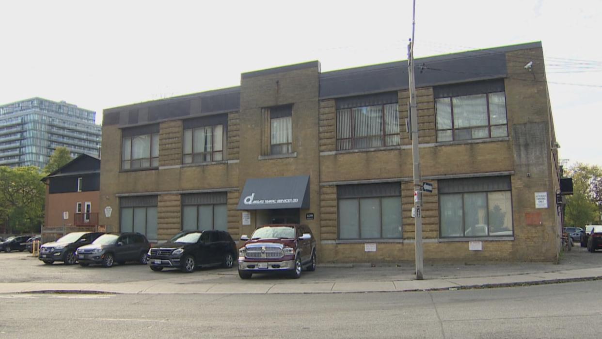 The city says it will convert this commercial building at 629 Adelaide St. W. into a 24-hour respite centre for unhoused people. The respite centre is slated to open early next year. Local residents, however, say they are concerned. (CBC - image credit)