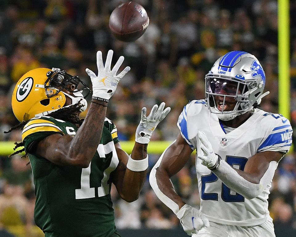 Packers wide receiver Davante Adams catches a pass against Lions cornerback Ifeatu Melifonwu during the second half of the Lions' 35-17 loss on Monday, Sept. 20, 2021, in Green Bay, Wisconsin.