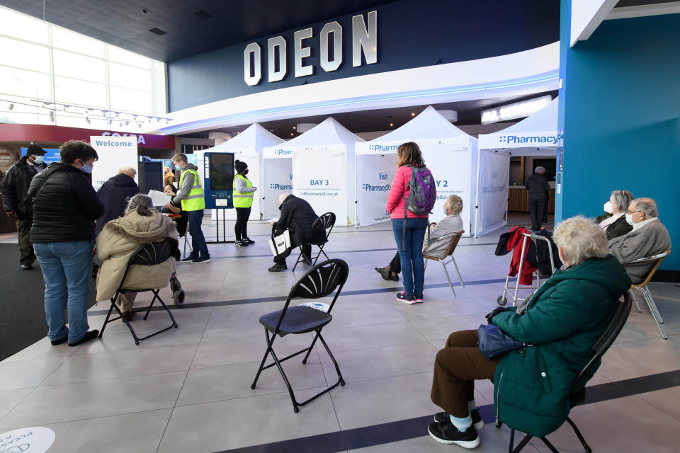 EDITORIAL USE ONLY People wait to receive the Oxford/AstraZeneca vaccine at the opening of the first Pharmacy2U Covid-19 vaccination centre at the Odeon Cinema in Aylesbury.