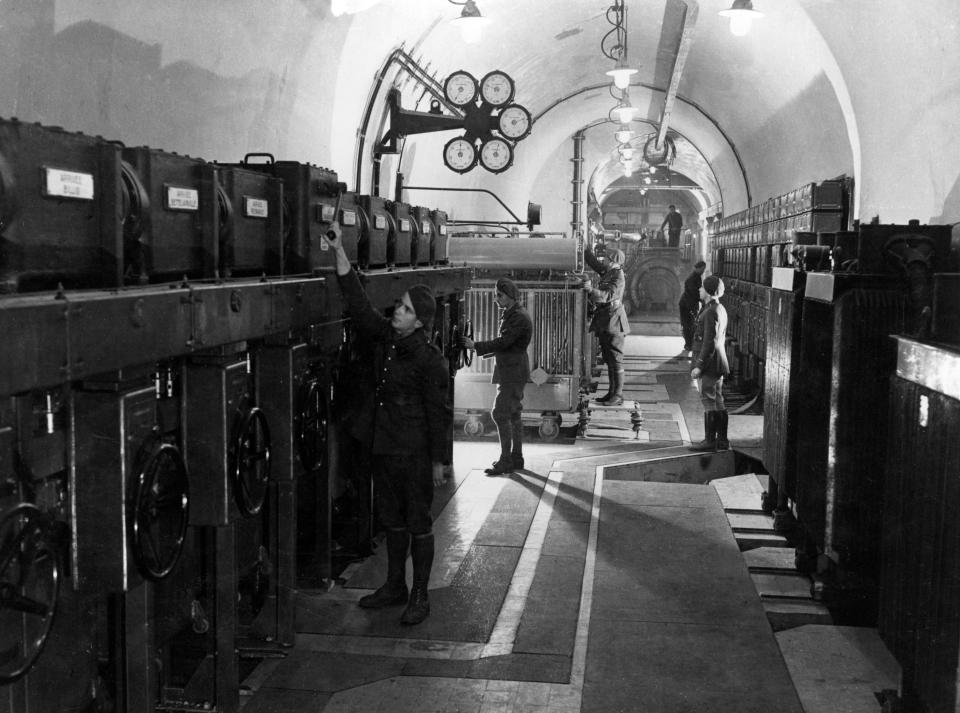 A photo of French soliders checking equipment in one of their underground tunnels.