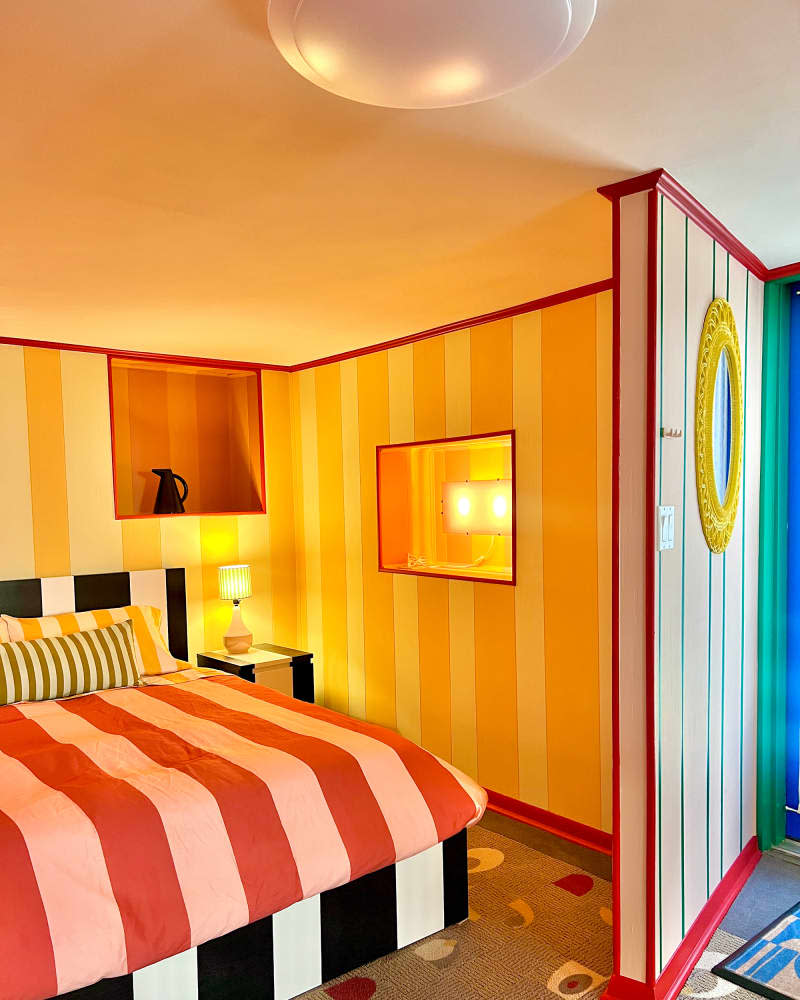 Colorful striped bedroom after remodel.