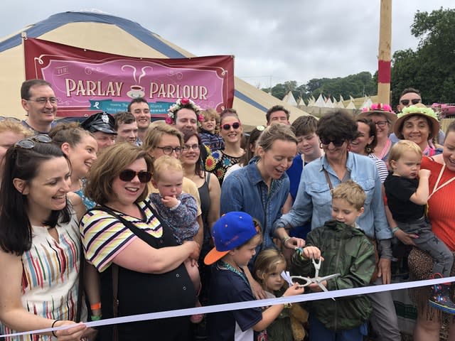 Emily Eavis, centre, opening the new Parlay Parlour in The Park on the first day of the Glastonbury Festival at Worthy Farm in Somerset 