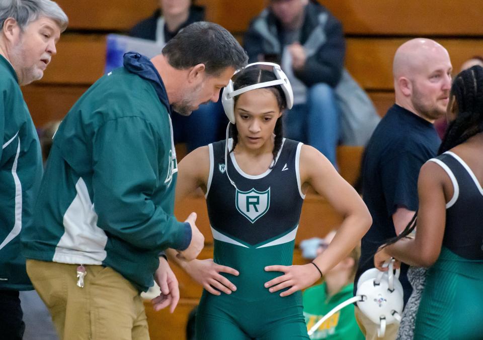 Richwoods girls wrestling coach Rob Penney shares a few words of advice for junior Kalia Williams after her victory in a match Saturday, Jan. 28, 2023 at Richwoods High School.