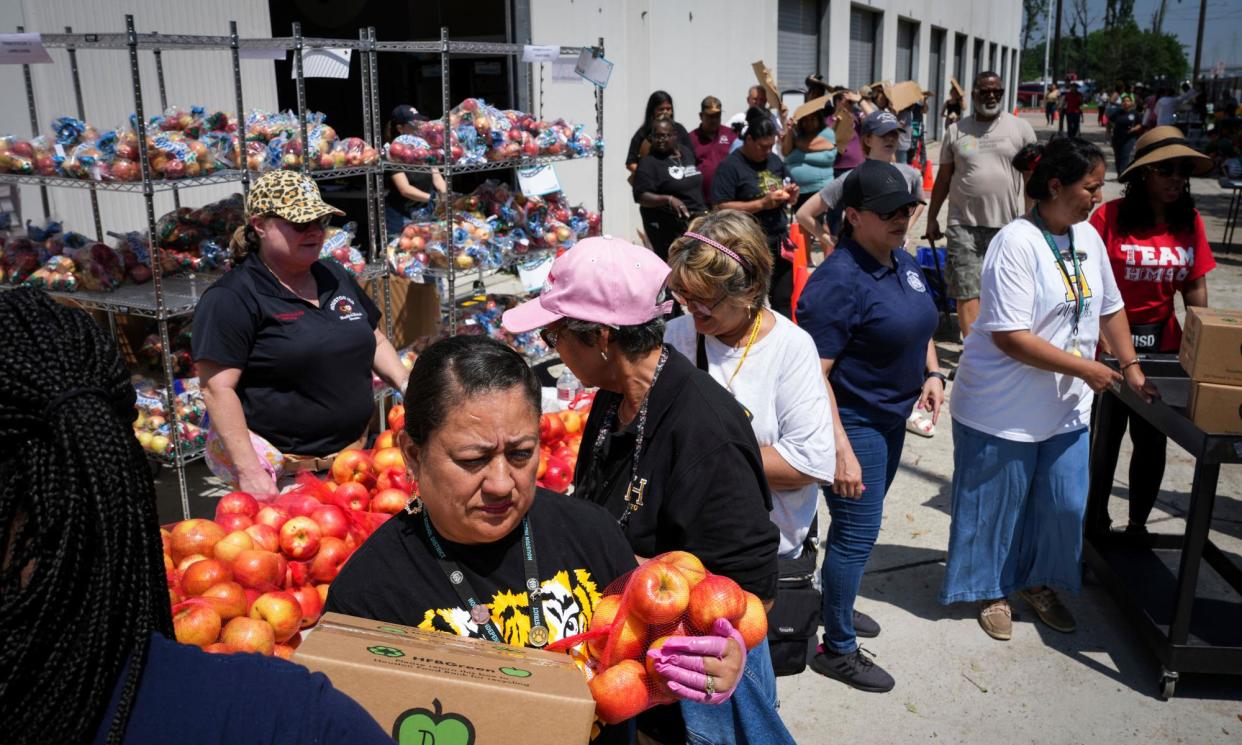 <span>Volunteers provide food and water to people without power in Houston.</span><span>Photograph: Jon Shapley/AP</span>