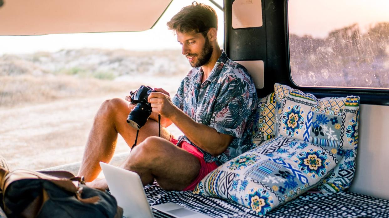 Smiling man using camera.