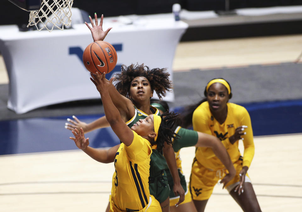 West Virginia guard Kirsten Deans (3) shoots while defended by Baylor guard DiDi Richards during the first half of an NCAA college basketball game Thursday, Dec. 10, 2020, in Morgantown, W.Va. (AP Photo/Kathleen Batten)