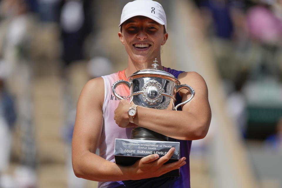 Poland's Iga Swiatek holds the trophy after winning the women's final of the French Open tennis tournament against Italy's Jasmine Paolini at the Roland Garros stadium in Paris, France, Saturday, June 8, 2024. (AP Photo/Thibault Camus)