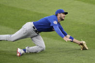 Chicago Cubs' Kris Bryant can't make the catch on a ball hit by Cleveland Indians' Cesar Hernandez in the fifth inning in a baseball game, Wednesday, Aug. 12, 2020, in Cleveland. Hernandez was safe at first base. (AP Photo/Tony Dejak)