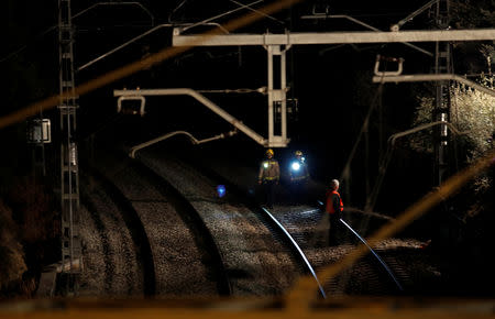 Security personnel inspect the railway after a train crash near Manresa, Spain, February 8, 2019. REUTERS/Albert Gea
