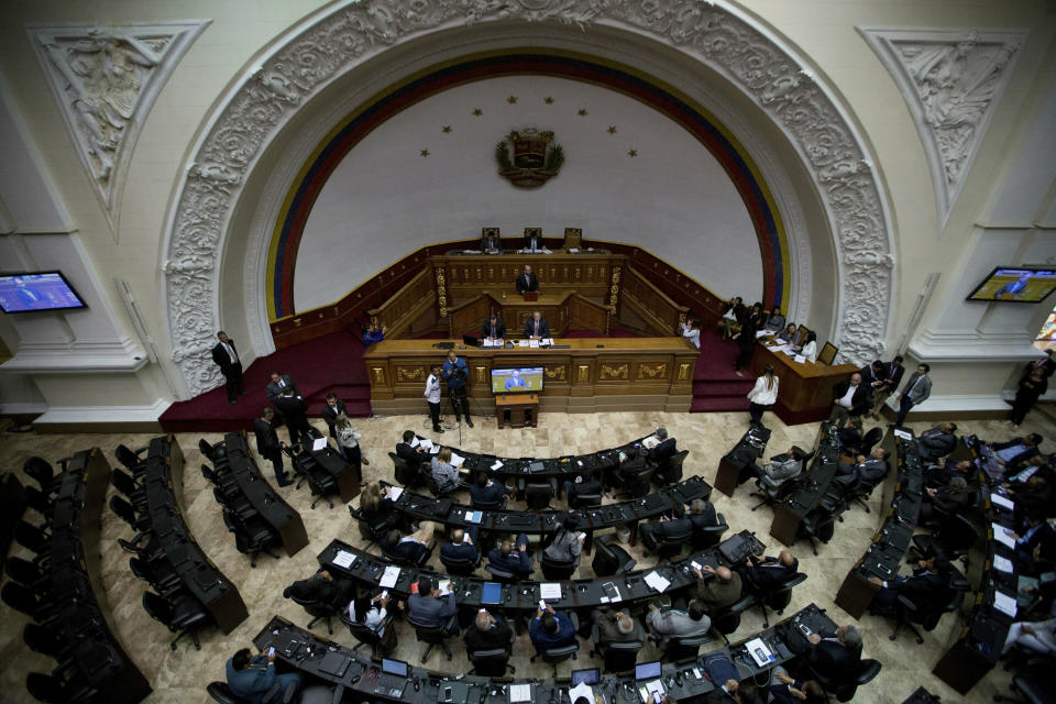 Lawmakers attend a session at the opposition-controlled National Assembly to debate actions against Venezuelan President Nicolas Maduro in Caracas, Venezuela, Tuesday, Jan. 15, 2019. The president is under heightened pressure from opposition politicians and foreign leaders urging him to step down. (AP Photo/Fernando Llano)