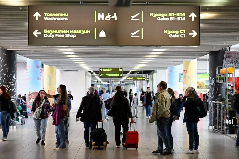 Passengers walk in the departure area of Sofia Airport after Bulgaria's official partial entry (air and sea) into the Europe's open-borders