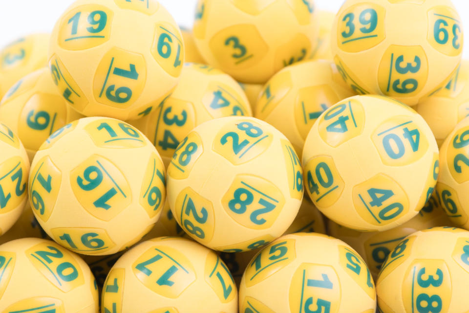 Oz Lotto balls are seen in a pile.