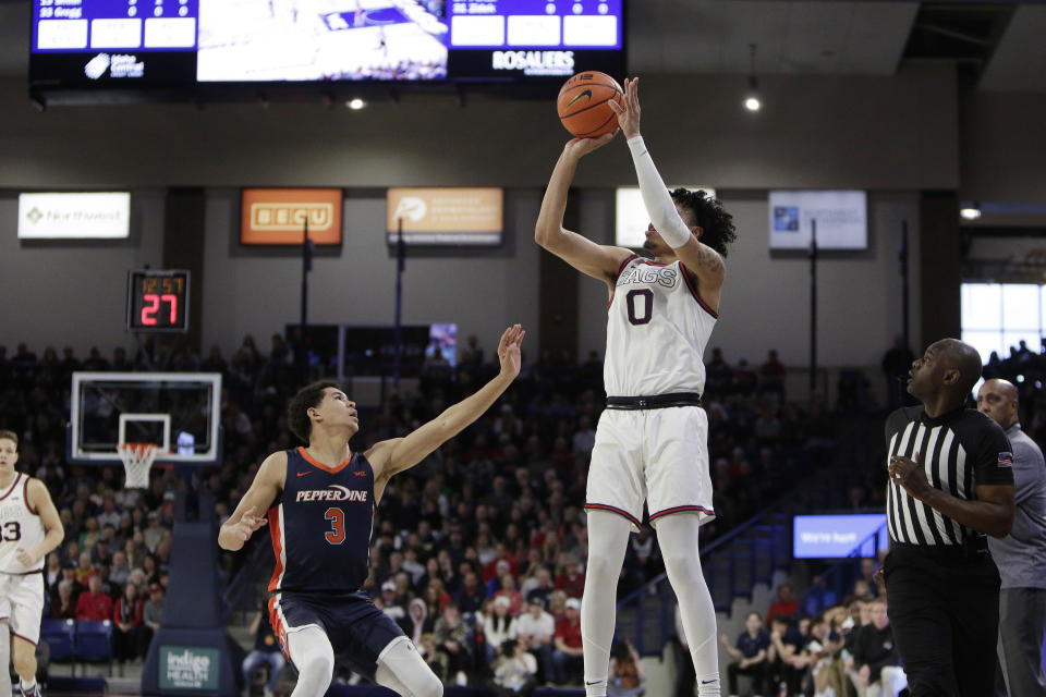 Gonzaga guard Julian Strawther (0) shoots over Pepperdine guard Malik Moore (3) during the first half of an NCAA college basketball game, Saturday, Dec. 31, 2022, in Spokane, Wash. (AP Photo/Young Kwak)