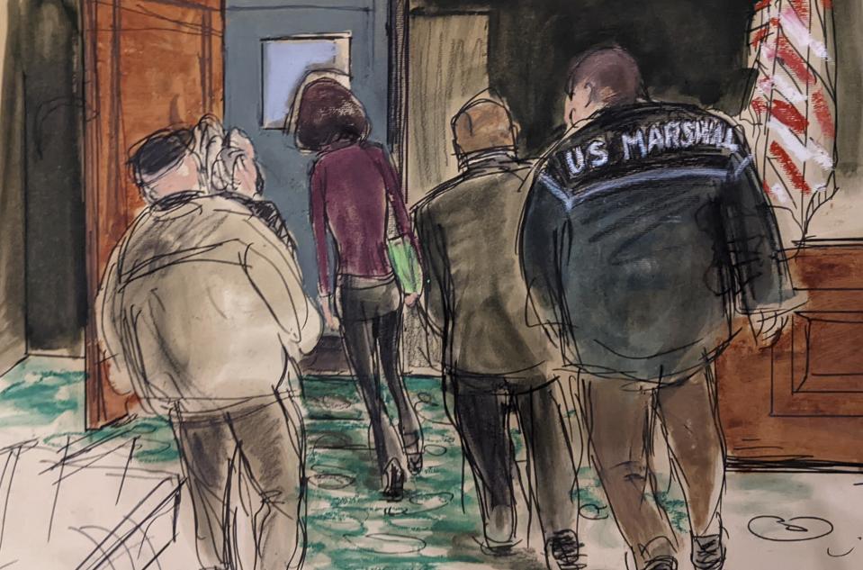 This courtroom sketch shows Ghislaine Maxwell, center, being led out of the courtroom into the lock up by four U.S. Marshals after a jury returned a guilty verdict in her sex trafficking trial, Wednesday Dec. 29, 2021, in New York. (Elizabeth Williams via AP)