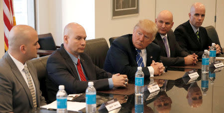 Republican presidential nominee Donald Trump meets with leadership members of the National Border Patrol Council while receiving the group's endorsement during a meeting at Trump Tower in Manhattan, New York, U.S., October 7, 2016. REUTERS/Mike Segar