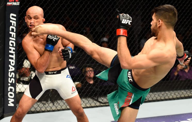 Yair Rodriguez kicks B.J. Penn during his second-round TKO victory in their featherweight bout in Phoenix on Sunday. (Jeff Bottari/Getty Images)