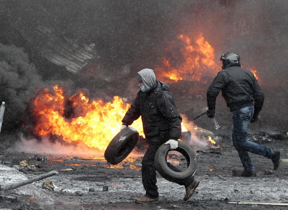 FILE In this file photo taken on Wednesday, Jan. 22, 2014, Protesters clash with police in central Kiev, Ukraine. Three people have died in clashes between protesters and police in the Ukrainian capital Wednesday, according to medics on the site, in a development that will likely escalate Ukraine's two month-long political crisis. The mass protests in the capital of Kiev erupted after Ukrainian President Viktor Yanukovych spurned a pact with the European Union in favor of close ties with Russia, which offered him a $15 billion bailout. (AP Photo/Sergei Chuzavkov, file)