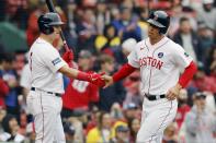 Boston Red Sox's Rob Refsnyder celebrates with Reese McGuire after scoring on a sacrifice fly by Enrique Hernandez during the sixth inning of a baseball game against the Los Angeles Angels, Monday, April 17, 2023, in Boston. (AP Photo/Michael Dwyer)