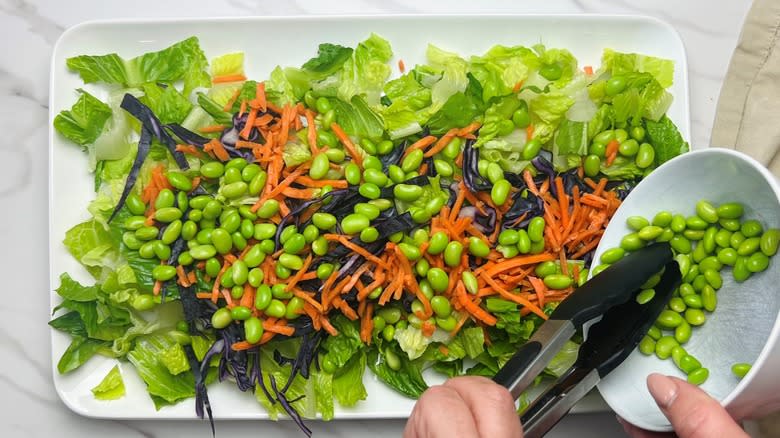 lettuce edamame and cabbage on white plate