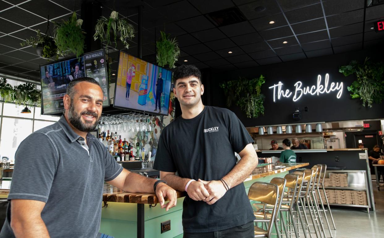 Co-owner Georgios Vasilakeris, left, and his son, Evan Vasilakeris, are shown in July 2021 at The Buckley Kitchen and Bar on Franklin Street in Framingham.