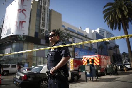 An LAPD officer blocks Highland Avenue after an incident outside the Dolby Theater during preparations ahead of the 87th Academy Awards in Hollywood, California February 19, 2015. REUTERS/Lucy Nicholson