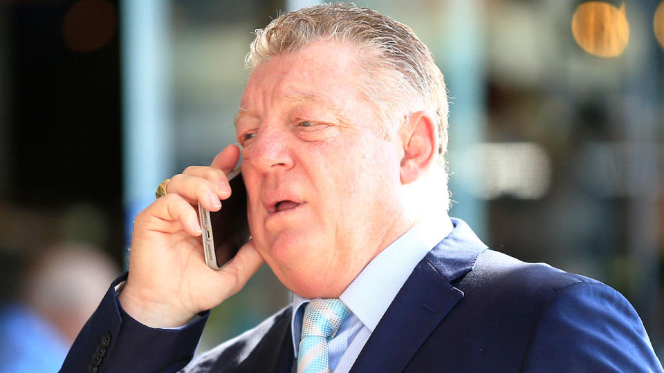 Pictured here, Channel Nine league commentator Phil Gould holds a mobile phone up to his ear.