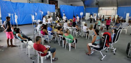 Patients are administered drips as they await the results of their dengue examination, in a medical tent in Rio Claro, Brazil March 5, 2015. REUTERS/Paulo Whitaker