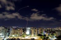 A streak of light is seen as Israel's Iron Dome anti-missile system intercepts rockets launched from the Gaza Strip towards Israel, as seen from Ashkelon, Israel