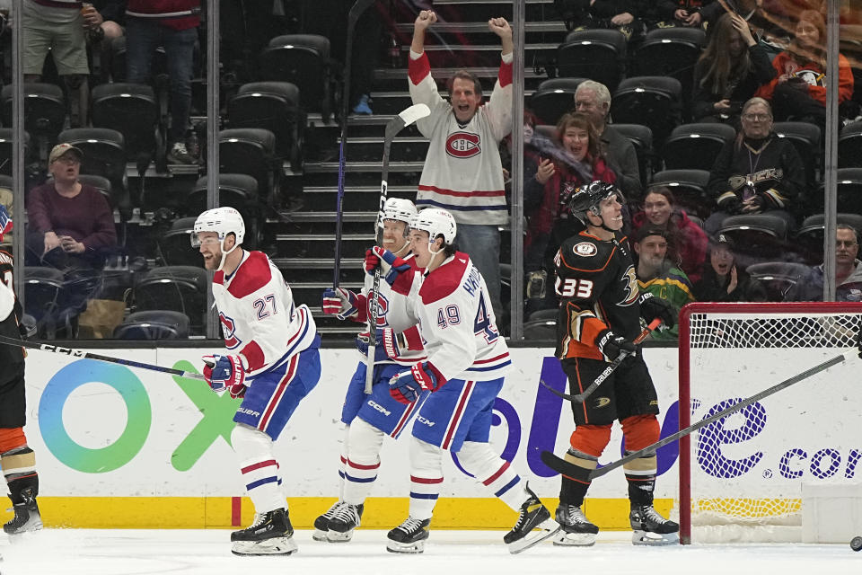 Montreal Canadiens left wing Jonathan Drouin, left, celebrates his goal with teammates as Anaheim Ducks right wing Jakob Silfverberg, right, stands by during the first period of an NHL hockey game Friday, March 3, 2023, in Anaheim, Calif. (AP Photo/Mark J. Terrill)