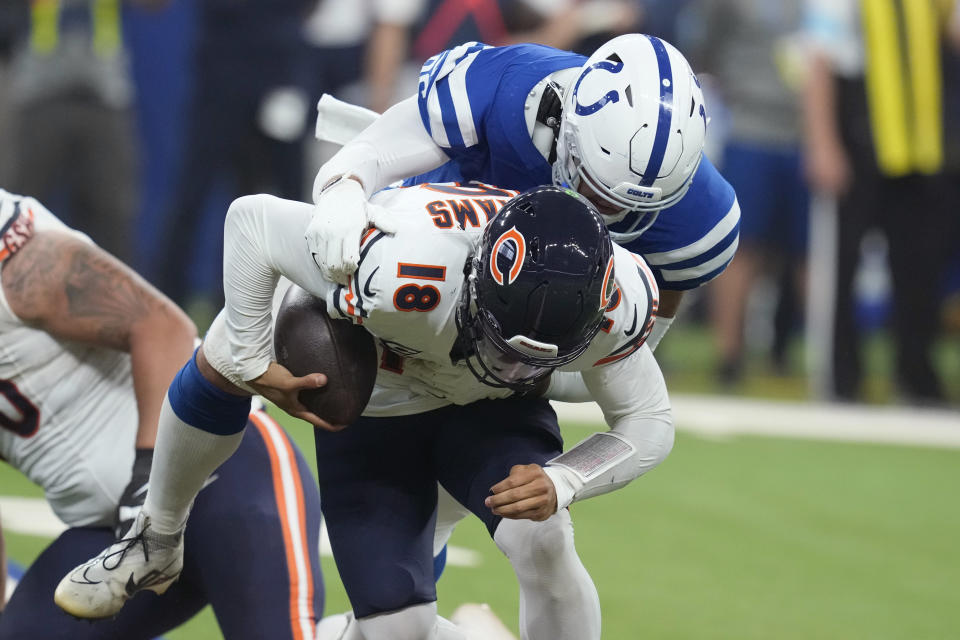 Chicago Bears quarterback Caleb Williams (18) is sacked by Indianapolis Colts defensive tackle Taven Bryan (96) during the first half of an NFL football game Sunday, Sept. 22, 2024, in Indianapolis. (AP Photo/Darron Cummings)