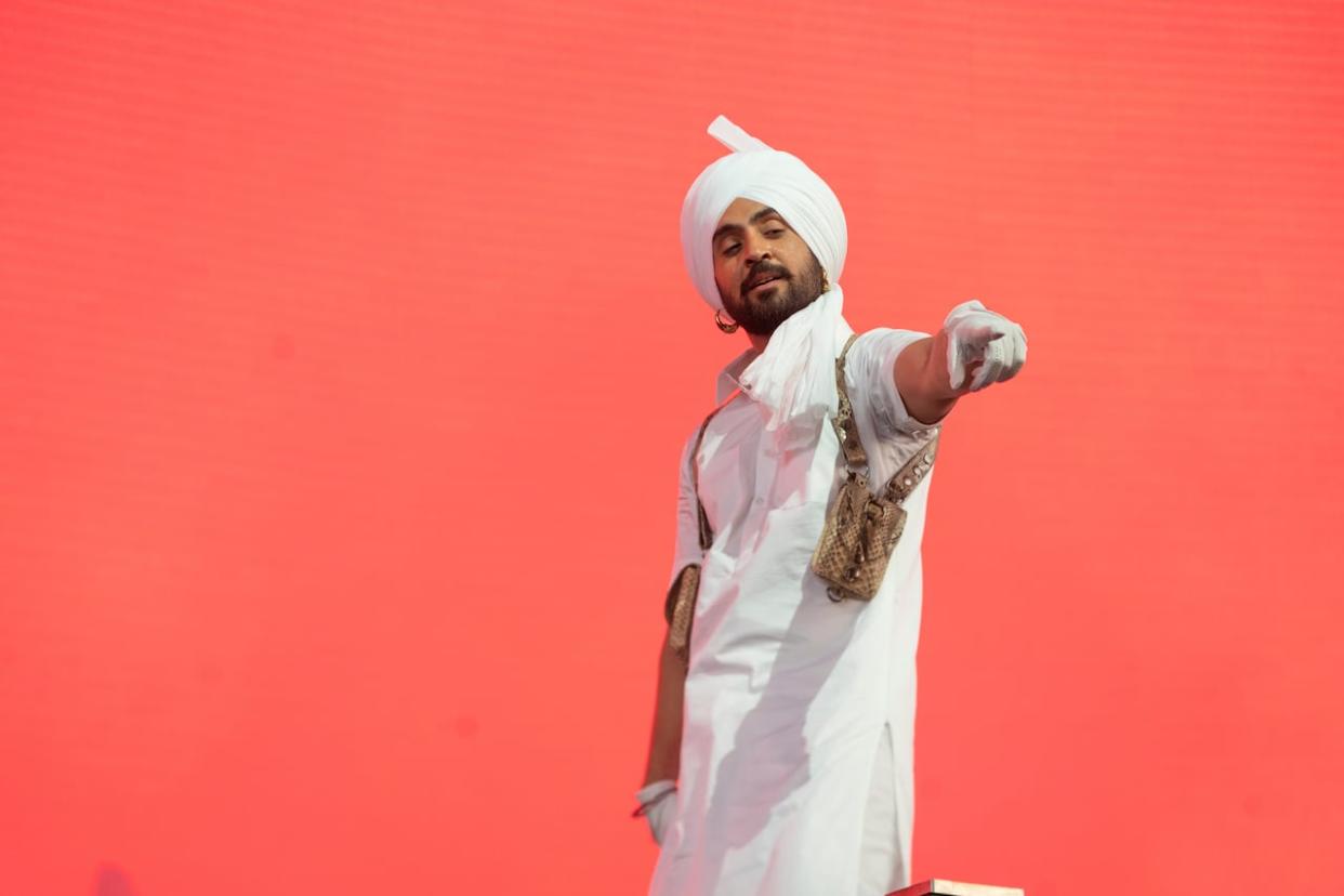 Diljit Dosanjh, shown here performing at the Coachella Music and Arts Festival, sent a letter to Emergency Preparedness Minister Harjit Sajjan asking for Canadian Armed Forces members to be used as a backdrop for a concert he held in April in Vancouver.  (Amy Harris/Invision/AP - image credit)